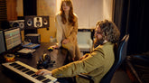 Mail producer and Female singer recording in studio
